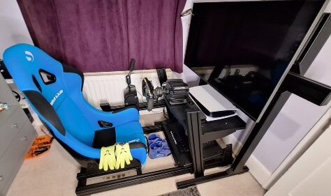 Fully mounted Buttkicker Gamer Pro under sim racing seat on PS5 setup
