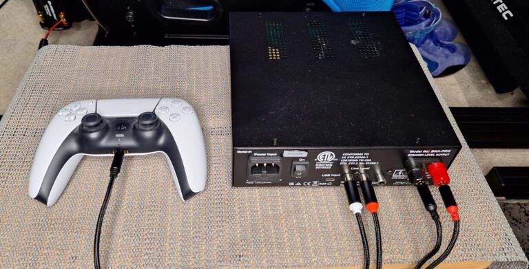 Buttkicker Gamer Pro connected to PS5 controller headphone jack