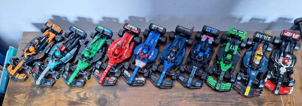 LEGO Speed Champions F1 cars arranged on a dedicated display shelf