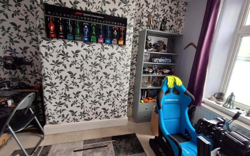 LEGO F1 display and sim racing setup in a games room
